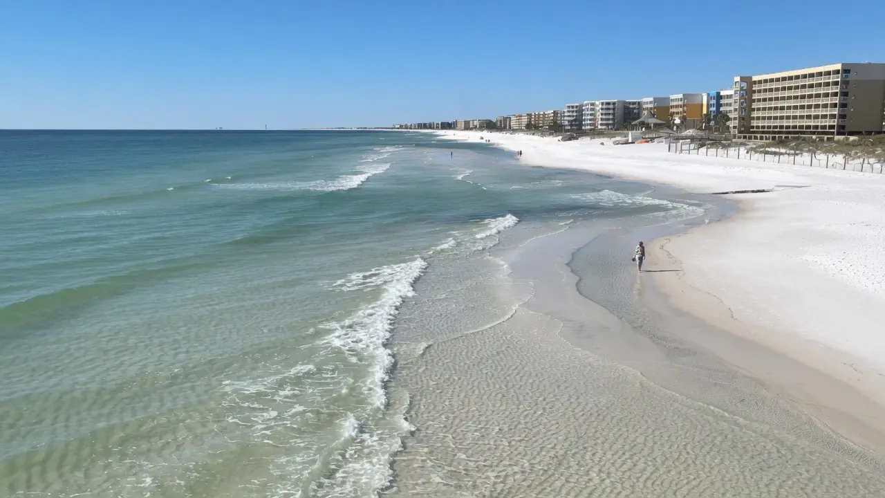 Calm emerald green Gulf water and white sand on a green flag day in Destin Florida